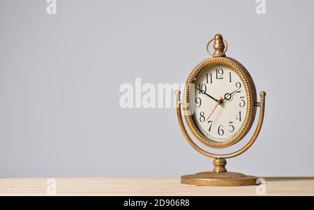Table metal vintage clock on gray background Stock Photo