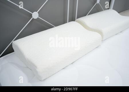 Orthopedic pillows for healthy sleep on a white mattress Stock Photo