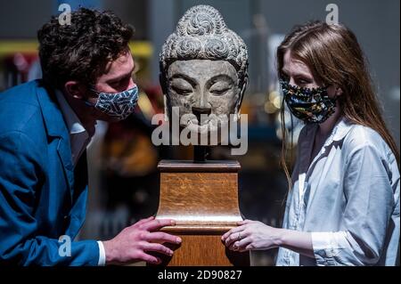 London, UK. 02nd Nov, 2020. A very rare grey limestone head of Buddha Shakyamuni Tang Dynasty, Longmen Caves, 7th century AD, est £ 80,000 - 120,000 - Fine Chinese Art part of a Preview of Bonhams' Asian Art Week sales due on 4/5 November, in new Bond Street. Credit: Guy Bell/Alamy Live News Stock Photo