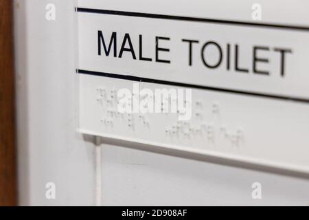 Disablility friendly toilet with braille tactile on signage Stock Photo