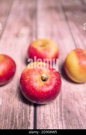 Red tasty fresh apples on a striped wooden surface Stock Photo