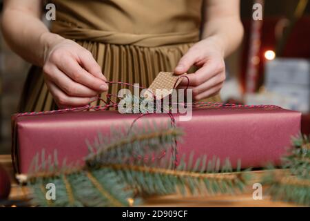 Gift workshop in a warm cozy room. Christmas decorations by fireplace. Stock Photo