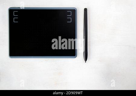 Drawing and painting tablet and pen on the white background, high angle view Stock Photo