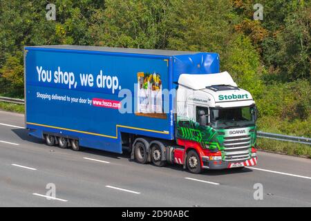 Tesco 'You shop we Drop' supermarket Haulage delivery trucks, lorry, heavy-duty vehicles, transportation, truck, cargo carrier, Scania Tracy Molly R450 vehicle, European commercial transport industry HGV, M6 at Manchester, UK Stock Photo