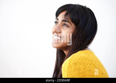 Close up side portrait of cheerful young Indian woman against isolated white background Stock Photo