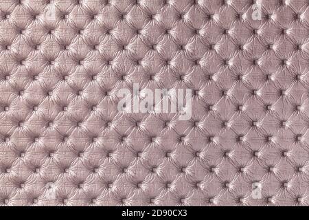 Texture of light brown leather background with capitone pattern, macro. Purple textile of retro Chesterfield style. Vintage fabric backdrop. Stock Photo