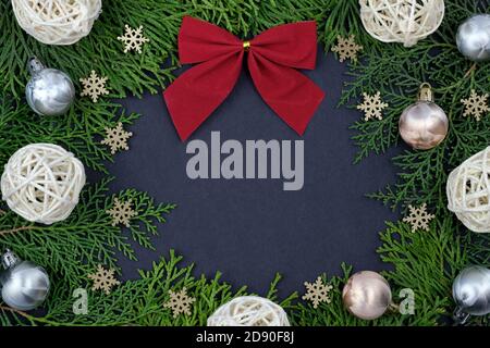 Christmas eve concept with red bow and copy space. christmas composition with red bow and christmas decorations top view. Thuja twigs, Christmas balls Stock Photo