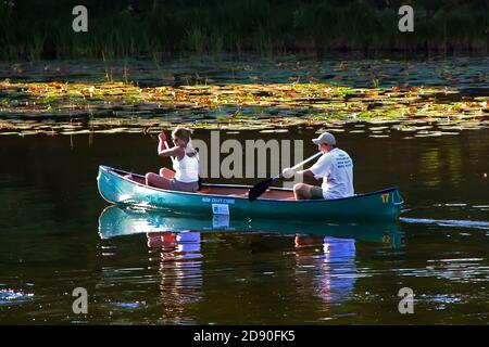 Couple canoe the Au Sable River for recreation and pleasure - Michigan Stock Photo