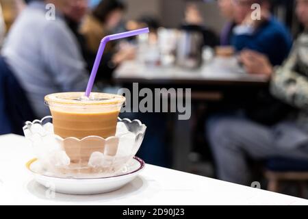 Cold silky smooth milk tea infused with ice in bowl Stock Photo