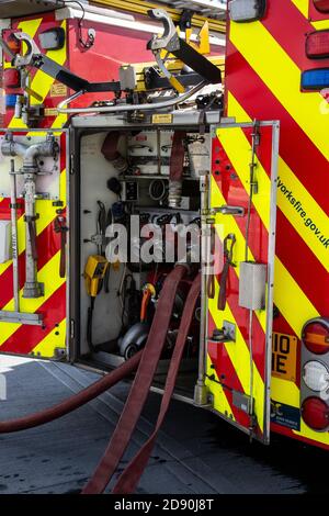 The rear view of an English fire engine showing the pumps, hoses gauges and miscellaneous firefighting equipment on board Stock Photo