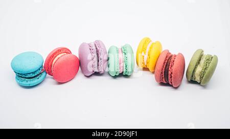 Pastel colored macarons sweet French dessert isolated on white background. Stock Photo
