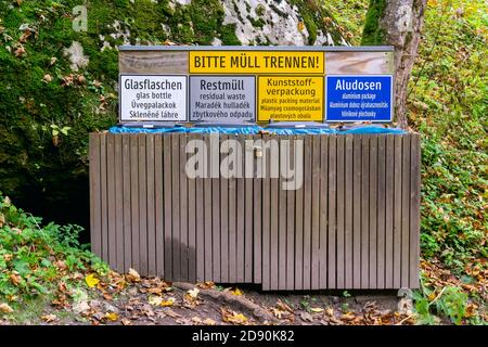 Waste container in the forest. German words Bitte Müll trennen means Please separate rubbish Stock Photo