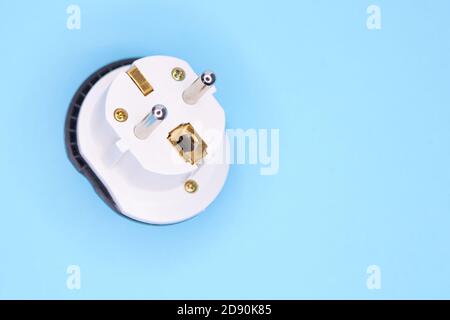 adapter electric adapter multifunctional white on a blue background Stock Photo