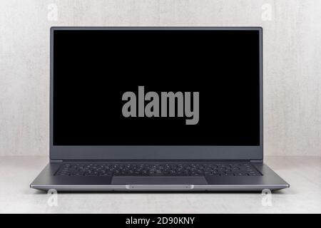 black mock up on a laptop screen on a gray background close up front view Stock Photo