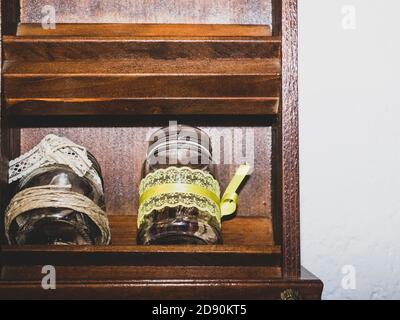 jars decorated with sugar and bottles of oil front view Stock Photo