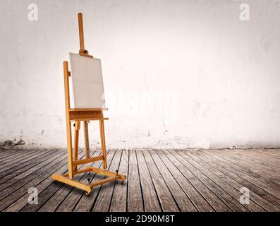 wooden easel in room with white wall and wood floor Stock Photo