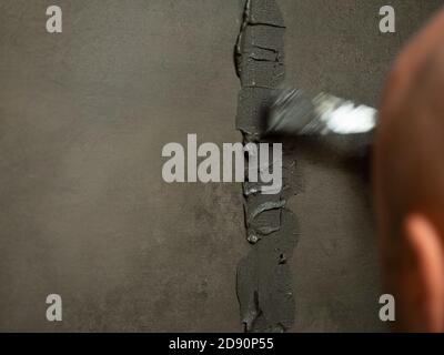worker putty shower on construction site for renovation Stock Photo
