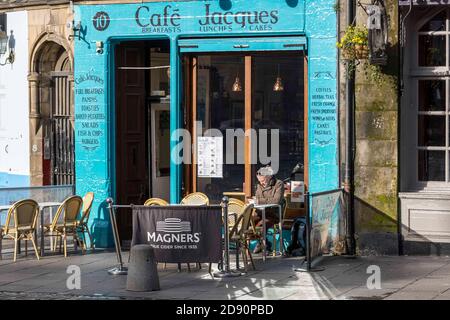 Edinburgh, United Kingdom. 02 November, 2020 Pictured: A lone diner sits outside a cafe in Edinburgh’s Grassmarket. Edinburgh enters into the Scottish Government Tier 3 of the COVID controls. Credit: Rich Dyson/Alamy Live News Stock Photo