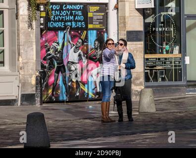 Edinburgh, United Kingdom. 02 November, 2020 Pictured: Two tourists take a selfie infront of closed cafe’s and Dance base studio. Edinburgh enters into the Scottish Government Tier 3 of the COVID controls. Credit: Rich Dyson/Alamy Live News Stock Photo