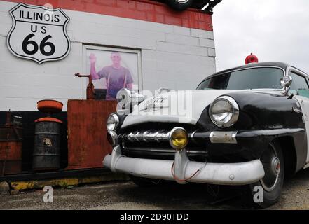 A classic police car is parked on display at Dick's Towing, a business on Route 66 in Joliet, Illinois. Stock Photo