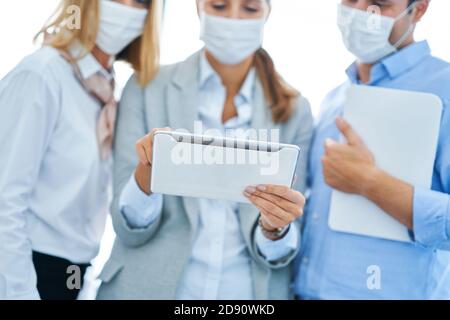 Team of businesspeople working in protective masks Stock Photo