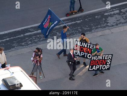 Austin, TX USA 30OCT20: Supporters of President Donald Trump  block a Biden-Harris campaign bus at the AFL-CIO office parking lot in downtown Austin. Two signs refer to an unfounded news report of incriminating evidence found on a computer owned by the son of Trump's rival, Democratic presidential candidate Joe Biden. Stock Photo