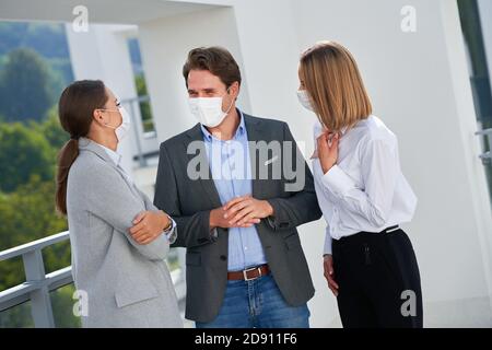 Team of businesspeople working in protective masks Stock Photo