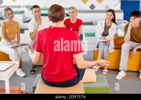 rear view on male instructor talking with students, giving lessons of first aid Stock Photo