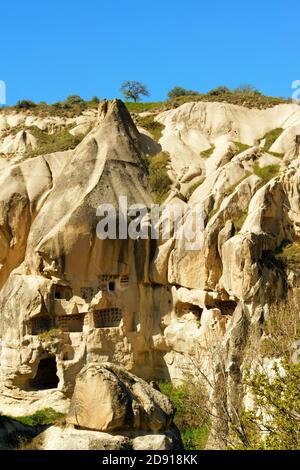 The ancient town of Goreme and its houses and churches carved in the stone among the Fairy Chimneys rock formations in Cappadocia, Turkey Stock Photo