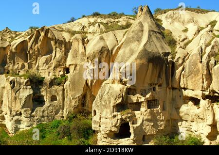 The ancient town of Goreme and its houses and churches carved in the stone among the Fairy Chimneys rock formations in Cappadocia, Turkey Stock Photo