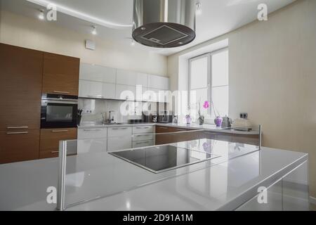 Modern electric stove surface in white light kitchen close up Stock Photo