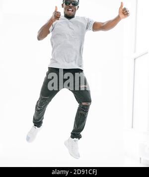 in full growth. happy dancing guy showing thumbs up. Stock Photo