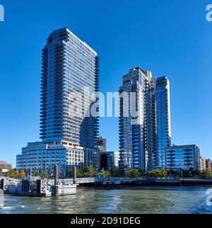Two contemporary high-rise apartment towers, Level and The Edge, line the East River waterfront in in North Williamsburg. Stock Photo