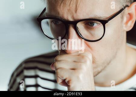 Thoughtful male entrepreneur wear glasses thinking, solving problem. Pensive upset exhausted guy feeling frustrated depressed tired. Mental health, af Stock Photo