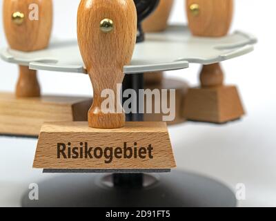 Wooden stamp with the imprint 'Risikogebiet', translation 'risk area' Stock Photo