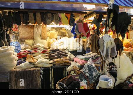 a lot of winter warm clothes in market for sale, shopping on holidays, black friday and xmas Stock Photo