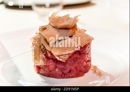 Alba white truffle sliced on raw minced meat from Piedmontese Fassona breed cattle Stock Photo