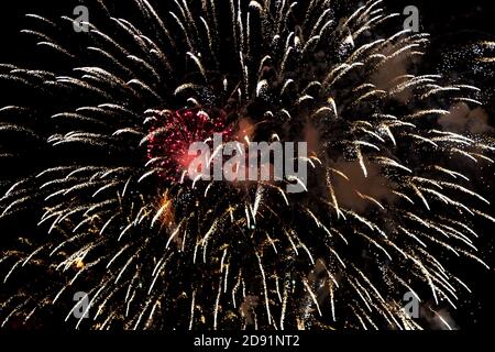Looking up at fireworks exploding against a night sky Stock Photo