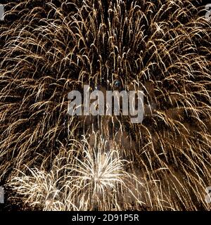Looking up at fireworks exploding against a night sky Stock Photo