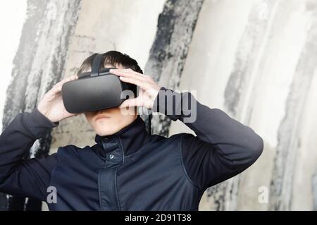 portrait of galactic soldier wearing VR glasses, security guard and police inspector using future virtual reality technologies protect the law Stock Photo