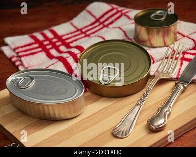 Different types of cans with prepared foods for consumption, vegetables, fish and meat Stock Photo