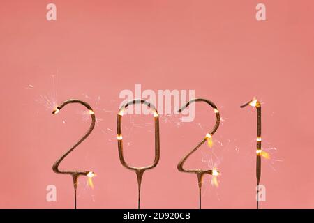 Burning festive sparklers in the shape of 2021 digits. Stock Photo
