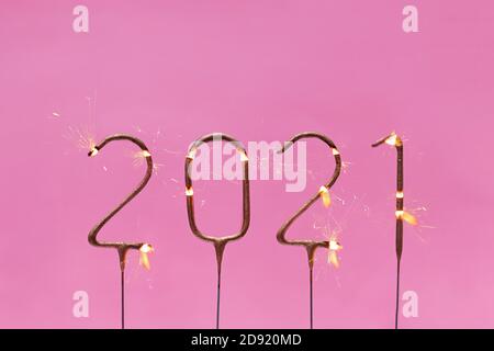 Burning festive sparklers in the shape of 2021 digits Stock Photo