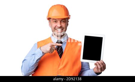 Builder Showing Tablet Pointing Finger At Empty Screen, White Background Stock Photo