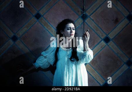 Juliette contemplates taking poison: Leontina Vaduva (Juliette) in ROMEO ET JULIETTE at The Royal Opera House, Covent Garden, London WC2  28/10/1994  music: Charles-Francois Gounod  libretto: Jules Barbier & Michel Care after Shakespeare  conductor: Charles Mackerras  design: Carlo Tommasi  lighting: Bruno Boyer  director: Nicolas Joel Stock Photo