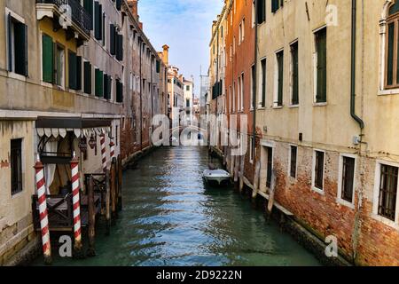 A narrow canal in the Venetian Lagoon with a secondary hotel entrance on the foreground, Venice, UNESCO World Heritage Site, Veneto, Italy, Europe Stock Photo