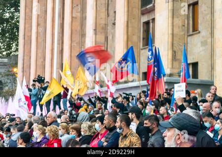 1 november, 2020. Tbilisi.Republic of Georgia. Crowd of people with posters and flags standing in front of parliament building during post election pr Stock Photo