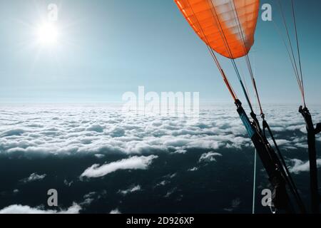 Paragliding above the clouds. Outdoor aerial adventure photography, extreme sports. Stock Photo