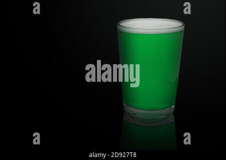 Cold craft green beer isolated on black background. Low key. Stock Photo
