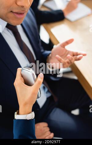 cropped view of correspondent with dictaphone interviewing indian politician gesturing during press conference Stock Photo